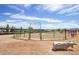 Equestrian arena with fencing, dirt ground, and decorative bull statue under sunny skies at 20329 E Bronco Dr, Queen Creek, AZ 85142