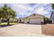 Spacious single-story home with a wide driveway and a well-maintained front yard at 20329 E Bronco Dr, Queen Creek, AZ 85142