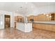 Well-lit kitchen featuring stainless steel appliances, light wood cabinets, and a spacious island at 20329 E Bronco Dr, Queen Creek, AZ 85142
