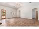 Bright living room with large tile flooring, a ceiling fan, and ample natural light at 20329 E Bronco Dr, Queen Creek, AZ 85142