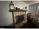 Stone fireplace adding character and warmth to the room, complemented by shelving and decorative items at 216 N 88Th St, Mesa, AZ 85207