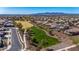 Community aerial view of well-maintained neighborhood with grassy areas, walking path, and mature landscaping at 27621 N 174Th Dr, Surprise, AZ 85387
