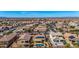 Scenic aerial view of a residential neighborhood featuring homes with pools, solar panels, and lush landscaping at 27621 N 174Th Dr, Surprise, AZ 85387