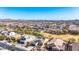Wide aerial view of a desert community showcasing homes with solar panels and stunning mountain vistas at 27621 N 174Th Dr, Surprise, AZ 85387