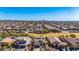 Expansive aerial view of a residential community with mountain views, highlighting well-maintained homes and landscaping at 27621 N 174Th Dr, Surprise, AZ 85387