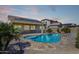Stunning backyard showcasing a pool, patio, and solar panels against a picturesque sunset backdrop at 27621 N 174Th Dr, Surprise, AZ 85387