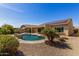 Inviting backyard with a refreshing pool, mature landscaping, and an extended covered patio at 27621 N 174Th Dr, Surprise, AZ 85387
