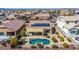 Backyard aerial view showcasing a private kidney-shaped pool, covered patio, and solar panels for energy efficiency at 27621 N 174Th Dr, Surprise, AZ 85387