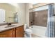 Bathroom features a single sink vanity, granite countertops, and tub with shower at 27621 N 174Th Dr, Surprise, AZ 85387