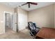 Bedroom featuring neutral carpet, a ceiling fan, and double door closet at 27621 N 174Th Dr, Surprise, AZ 85387