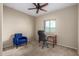 Bedroom featuring neutral carpet, a ceiling fan, and a small window at 27621 N 174Th Dr, Surprise, AZ 85387