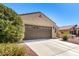Charming tan single-story home with three-car garage and well-maintained desert landscaping at 27621 N 174Th Dr, Surprise, AZ 85387