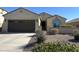 Charming single-story home with a three-car garage and a well-manicured desert landscape at 27621 N 174Th Dr, Surprise, AZ 85387