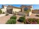 Single-story home with solar panels, three-car garage, and desert landscaping in front yard at 27621 N 174Th Dr, Surprise, AZ 85387