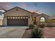 Charming single-story home features a three-car garage, covered entry, and well-maintained desert landscaping at 27621 N 174Th Dr, Surprise, AZ 85387