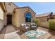 Inviting front porch features seating area with cushioned wicker chairs and a leafy area rug at 27621 N 174Th Dr, Surprise, AZ 85387