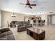 Open floorplan living room with ceiling fan, recessed lighting, and breakfast bar at 27621 N 174Th Dr, Surprise, AZ 85387