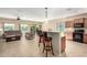 Open floorplan showcases bar seating, kitchen, living room with plush recliners and great natural light and backyard views at 27621 N 174Th Dr, Surprise, AZ 85387