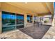 Spacious covered patio with tiled flooring and access to the backyard pool, perfect for outdoor entertaining at 27621 N 174Th Dr, Surprise, AZ 85387
