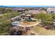 Aerial view of community playground with slides and climbing area surrounded by a walking path at 27621 N 174Th Dr, Surprise, AZ 85387