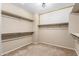 Spacious walk-in closet with ample shelving and an accent wall at 27621 N 174Th Dr, Surprise, AZ 85387
