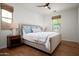 This bedroom features hardwood floors, neutral walls, two bedside tables with lamps, and a large window at 29192 N 129Th Ave, Peoria, AZ 85383