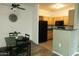 Dining area featuring a table with seating, adjacent kitchen, and decorative wall clock at 2929 W Yorkshire Dr # 1028, Phoenix, AZ 85027