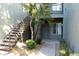 Building entrance with desert landscaping, a small tree, and stairway to the second floor at 2929 W Yorkshire Dr # 1028, Phoenix, AZ 85027