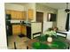 Open concept, eat-in kitchen flows into living room with wood table and black appliances at 2929 W Yorkshire Dr # 1028, Phoenix, AZ 85027