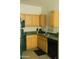Well-lit kitchen featuring light wood cabinets, black appliances, and tile flooring at 2929 W Yorkshire Dr # 1028, Phoenix, AZ 85027