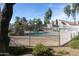 Community pool with a decorative fence and a waterfall feature surrounded by lush landscaping at 2929 W Yorkshire Dr # 1028, Phoenix, AZ 85027
