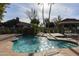 Sparkling community pool featuring a cascading waterfall, lounge chairs, and covered cabana at 2929 W Yorkshire Dr # 1028, Phoenix, AZ 85027