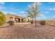 A desert landscaped backyard features a patio with seating and ample space for outdoor activities at 30056 N 129Th Ave, Peoria, AZ 85383