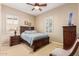 Bedroom featuring a wooden bed frame, side table, and neutral walls with two windows for natural light at 30056 N 129Th Ave, Peoria, AZ 85383