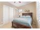 Bedroom featuring a wooden bed frame, side table, and neutral walls with a window for natural light at 30056 N 129Th Ave, Peoria, AZ 85383