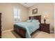 Comfortable bedroom with a queen-size bed, neutral decor, and natural light from a window at 30056 N 129Th Ave, Peoria, AZ 85383