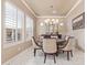 This dining room features a chandelier, marble floors and shutters at 30056 N 129Th Ave, Peoria, AZ 85383