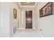 Foyer area featuring marble floors, a dark brown front door, and neutral paint at 30056 N 129Th Ave, Peoria, AZ 85383