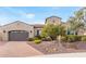 Charming home featuring a well-manicured front yard with desert landscaping and a two-car garage at 30056 N 129Th Ave, Peoria, AZ 85383