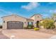 Charming stucco home featuring a brick driveway, two-car garage, and well-maintained landscaping at 30056 N 129Th Ave, Peoria, AZ 85383