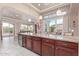 Open concept kitchen featuring an island with barstool seating and views into the living room at 30056 N 129Th Ave, Peoria, AZ 85383
