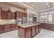 Open concept kitchen with a large island, stainless steel appliances, and custom cabinetry at 30056 N 129Th Ave, Peoria, AZ 85383