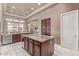 Open concept kitchen with a large island, wine fridge, and views into the dining area at 30056 N 129Th Ave, Peoria, AZ 85383