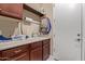 Laundry room featuring a sink with countertop space and upper cabinets for storage at 30056 N 129Th Ave, Peoria, AZ 85383
