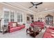 Open concept living room featuring tile floors, neutral paint and two red sofas at 30056 N 129Th Ave, Peoria, AZ 85383