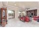 Spacious living room with tray ceilings, built-in cabinets, and sliding glass doors to the backyard at 30056 N 129Th Ave, Peoria, AZ 85383