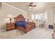 A spacious main bedroom boasts an ornate, dark-wood bed frame and neutral carpeting at 30056 N 129Th Ave, Peoria, AZ 85383