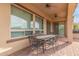 Covered patio with pavers, ceiling fans and outdoor dining set at 30056 N 129Th Ave, Peoria, AZ 85383