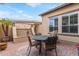 Charming outdoor patio setup with a table and chairs, perfect for enjoying the peaceful surroundings at 30056 N 129Th Ave, Peoria, AZ 85383