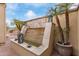 Close-up of an elegant stone water feature surrounded by lush greenery and decorative lanterns at 30056 N 129Th Ave, Peoria, AZ 85383